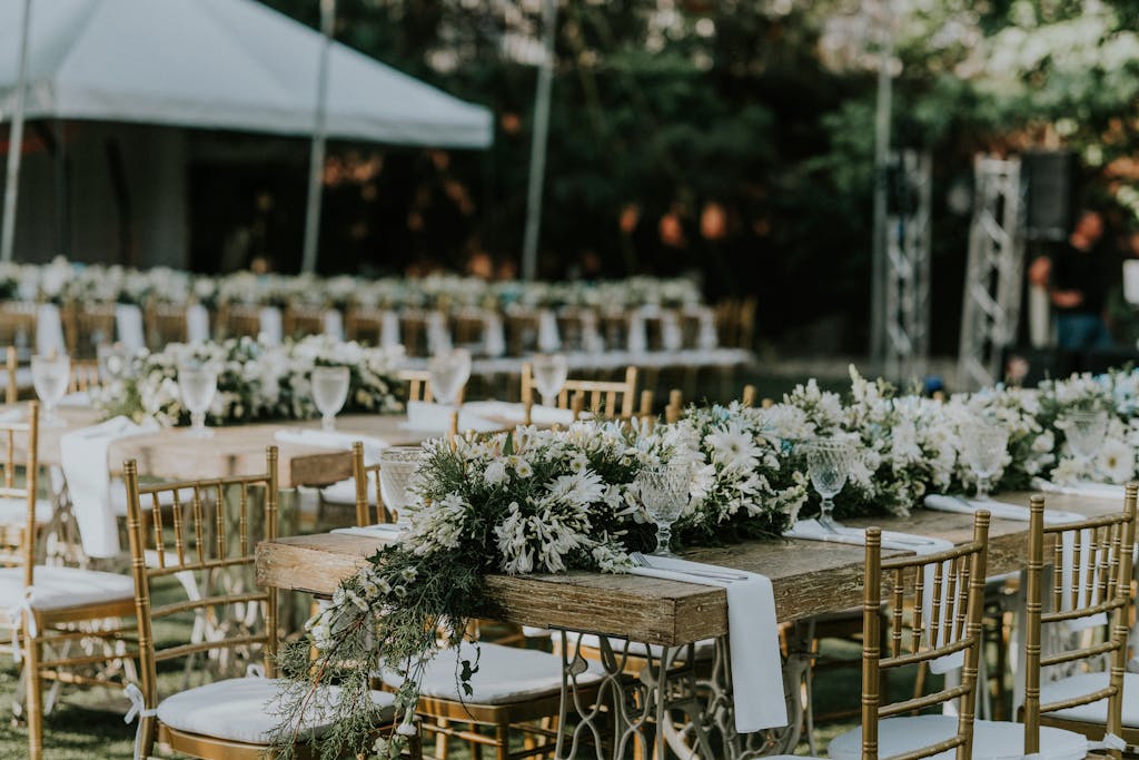 A Floral Arrangement of White and Green Flowers on Table Centerpiece